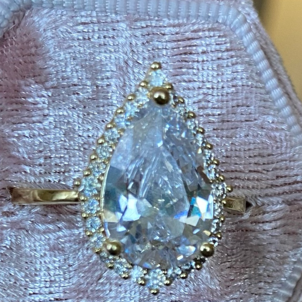 Teardrop white stone w/ white stone halo.